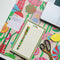 colorful notepad and pen sitting on the floral desk pad