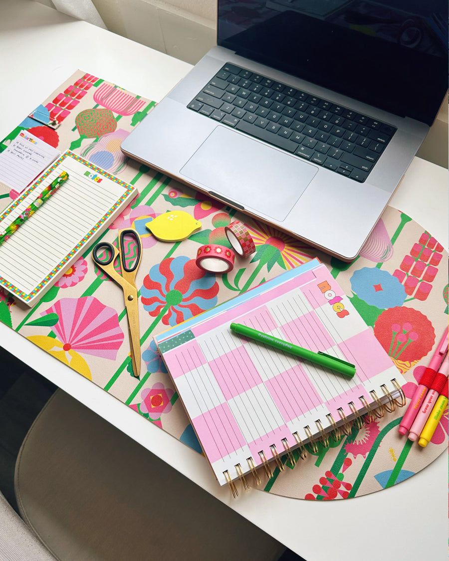 Floral desk pad with planner sitting on it