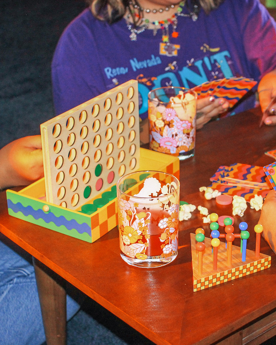 4-in-a-row game on table, with drinks and other games