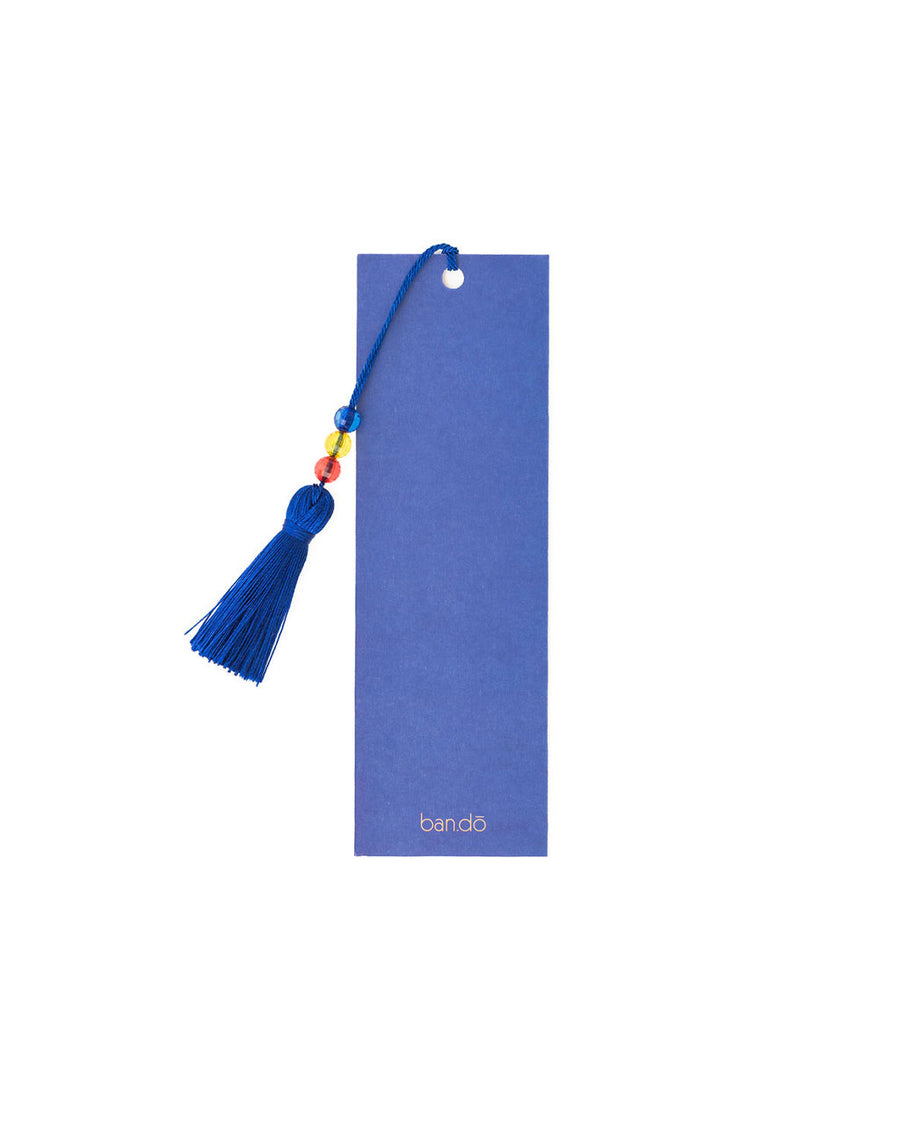 back view of blue bookmark with blue ground and 'in my happy place' with all over smiley print and blue tassel