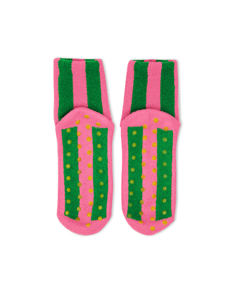 bottom view of pink and green vertical stripe cozy socks with green grippies in the bottom