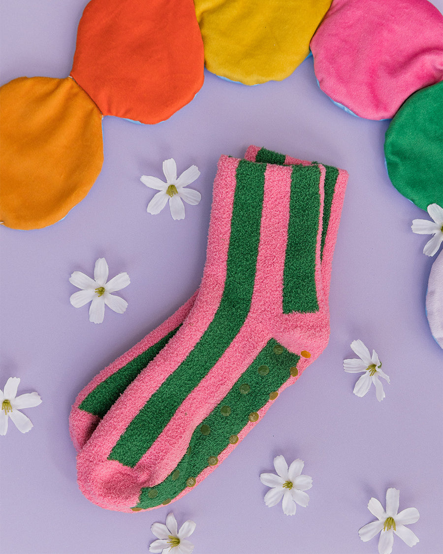 pink and green vertical stripe cozy socks with green grippies in the bottom