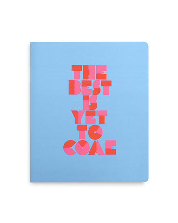 blue undated planner with pink and red block letters thats says 'the best is yet to come.'