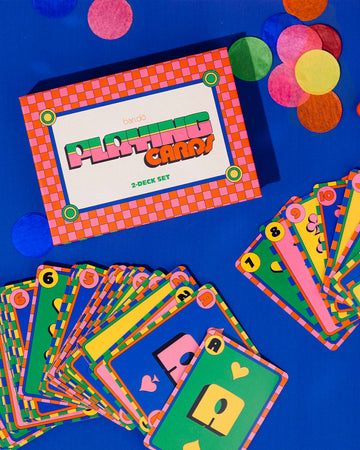 set of two playing card decks (rainbow squiggle and blue polka dot) and closed colorful box