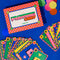 set of two playing card decks (rainbow squiggle and blue polka dot) and closed colorful box