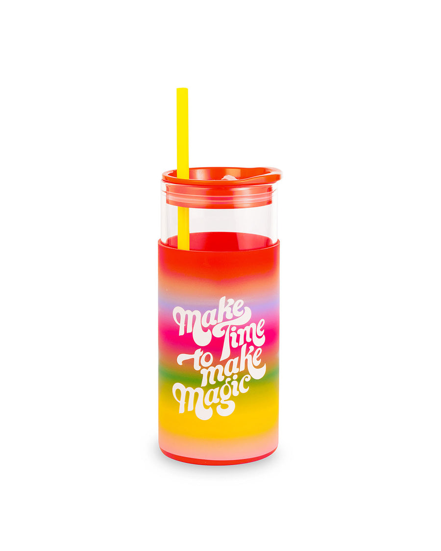 glass 20 oz tumbler with red lid, yellow straw, and rainbow ombre sleeve with white text 'make time to make magic' across the front