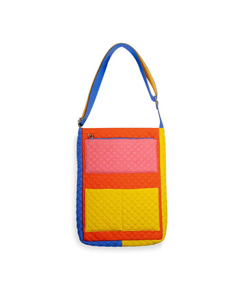 front of pink, yellow, red, and blue quilted laptop tote with various pockets