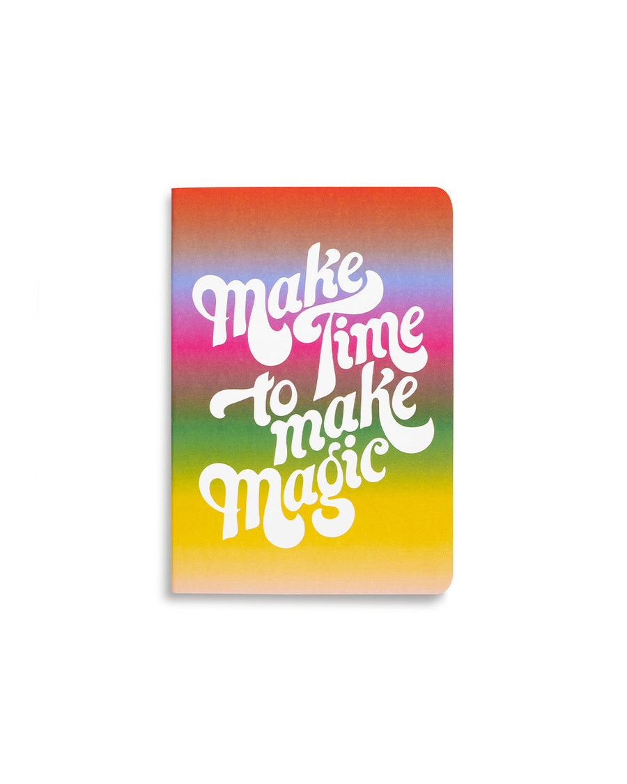 notebook with rainbow ombre ground and white 'make time to make magic' text