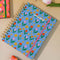 light blue 17-month planner with colorful tulip and star print on ombre ground surrounded by other planners