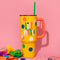 yellow mega 40 oz stainless steel tumbler with colorful 'life of the party' on the front