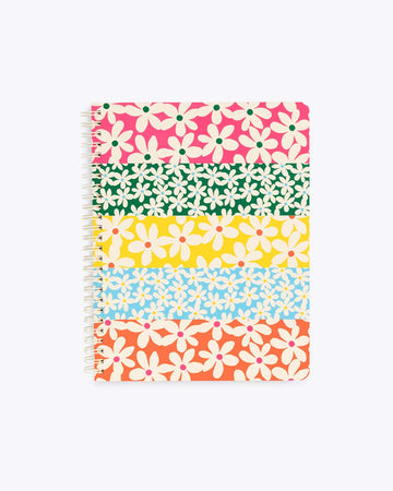mini notebook with a multi colored daisy pattern on the cover