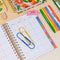yellow and blue giant paper clips on planner