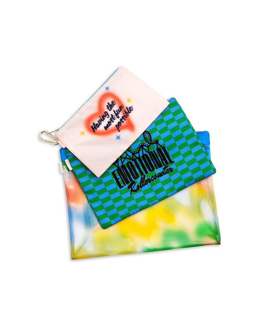 set of three beach pouches: cream 'having the most fun possible', checkered emotional rollercoaster, and neon colorful squiggles