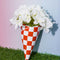 red and white checkered fair bag vase with flowers inside