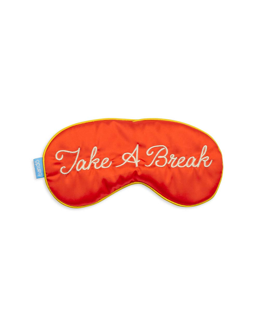 red satin eye mask with cursive 'take a break' across the front