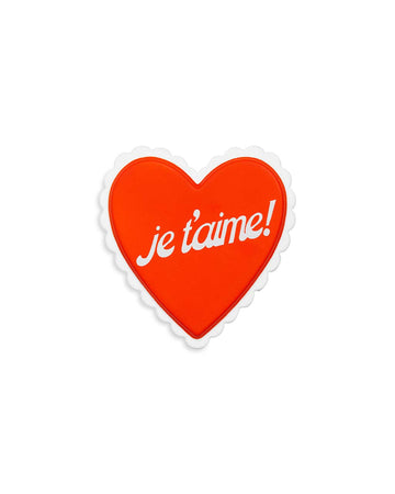 red heart shaped de-stress ball with white scalloped trim and white 'je t'aime!' across the front 