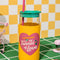 glass tumbler with yellow sleeve that says 'i got smooched at the tunnel of love', green lid and pink straw