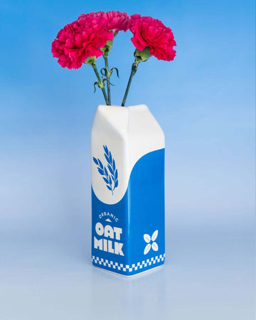oat milk carton ceramic vase with flowers inside