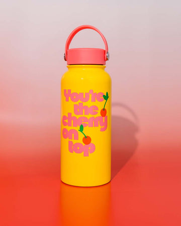 yellow steel water bottle with pink lid and pink 'you're the cherry on top' across the front on red and white gradient background