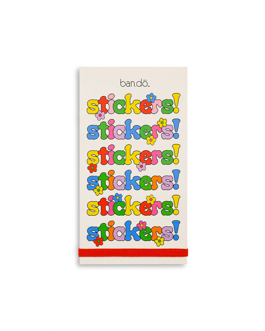 cream sticker book with multicolor 'stickers!' repeated across the front and red elastic closure
