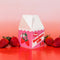 petite carton shaped strawberry milk vase surrounded by strawberries