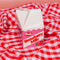 petite carton shaped strawberry milk vase on red and white checkered blanket
