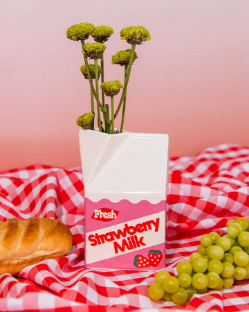 petite carton shaped strawberry milk vase with yellow flowers inside