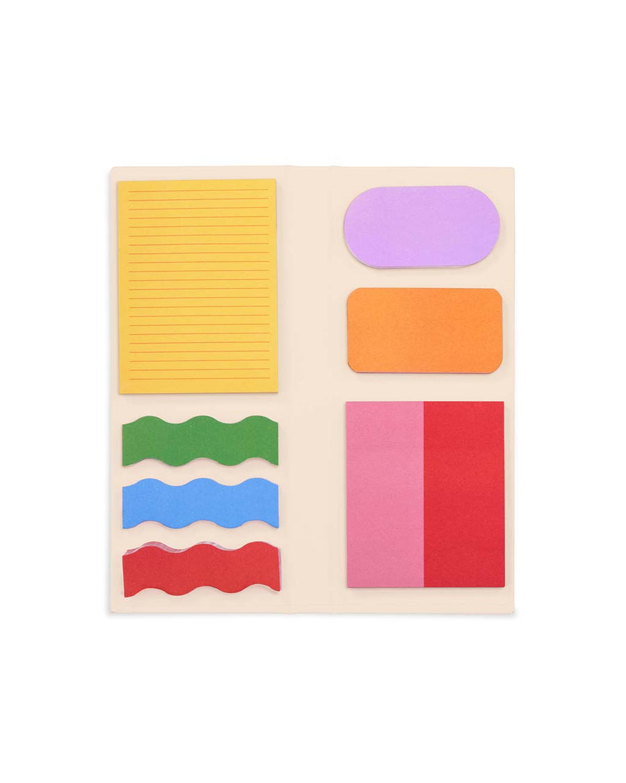 opened sticky note folio with cream ground and colorful shapes with black 'notes' and yellow elastic closure