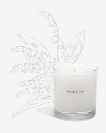 The Nouvelle Vague candle by Maison Louis Marie is white and comes in a clear glass tumbler.