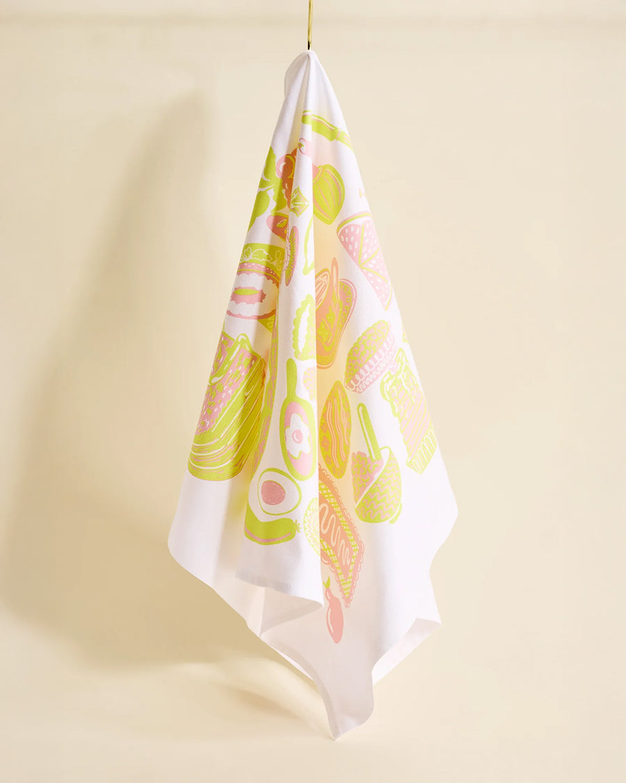 hanging light pink tea towel with yellow and pink breakfast food print