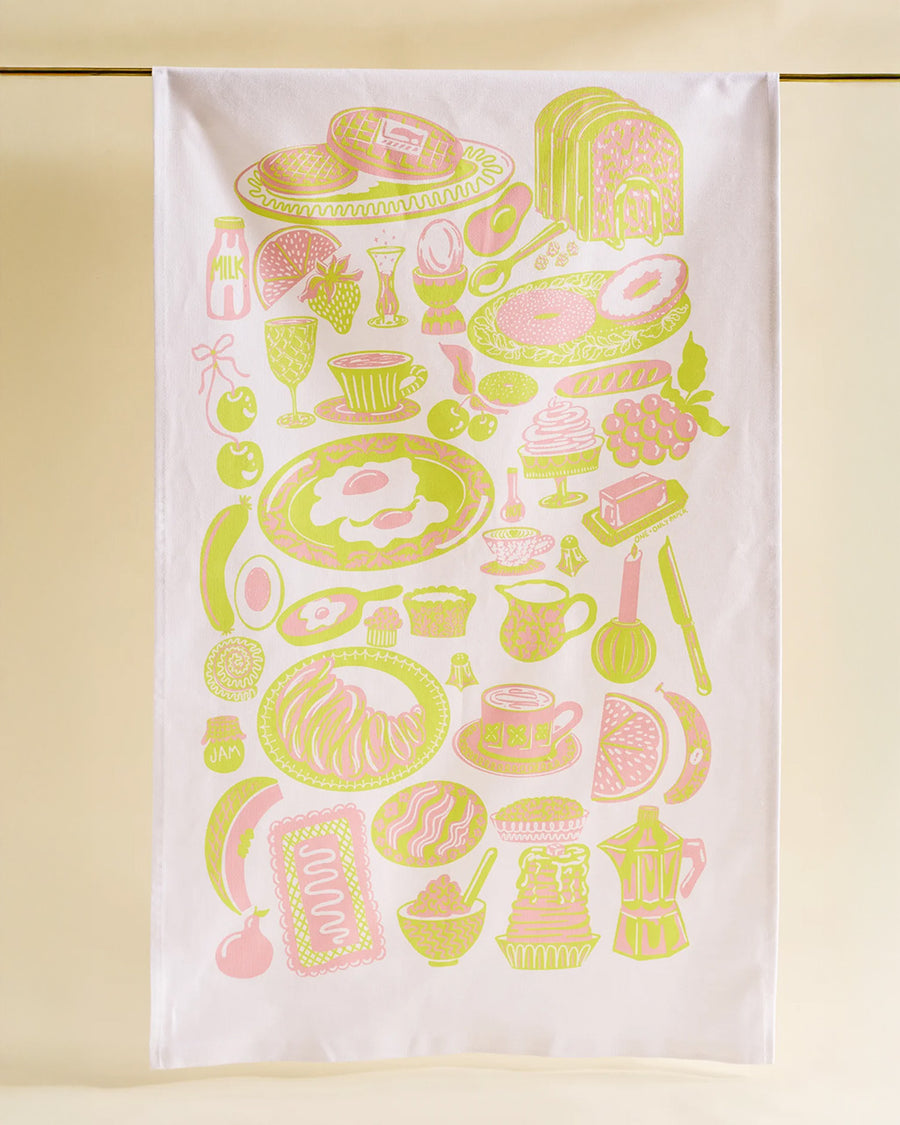 light pink tea towel with yellow and pink breakfast food print