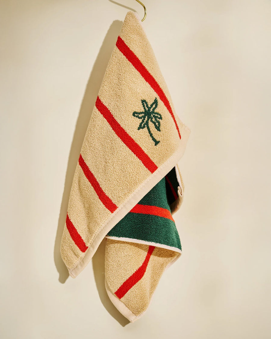 tan and red vertical stripe towel with darn green reverse side and embroidered palm tree print