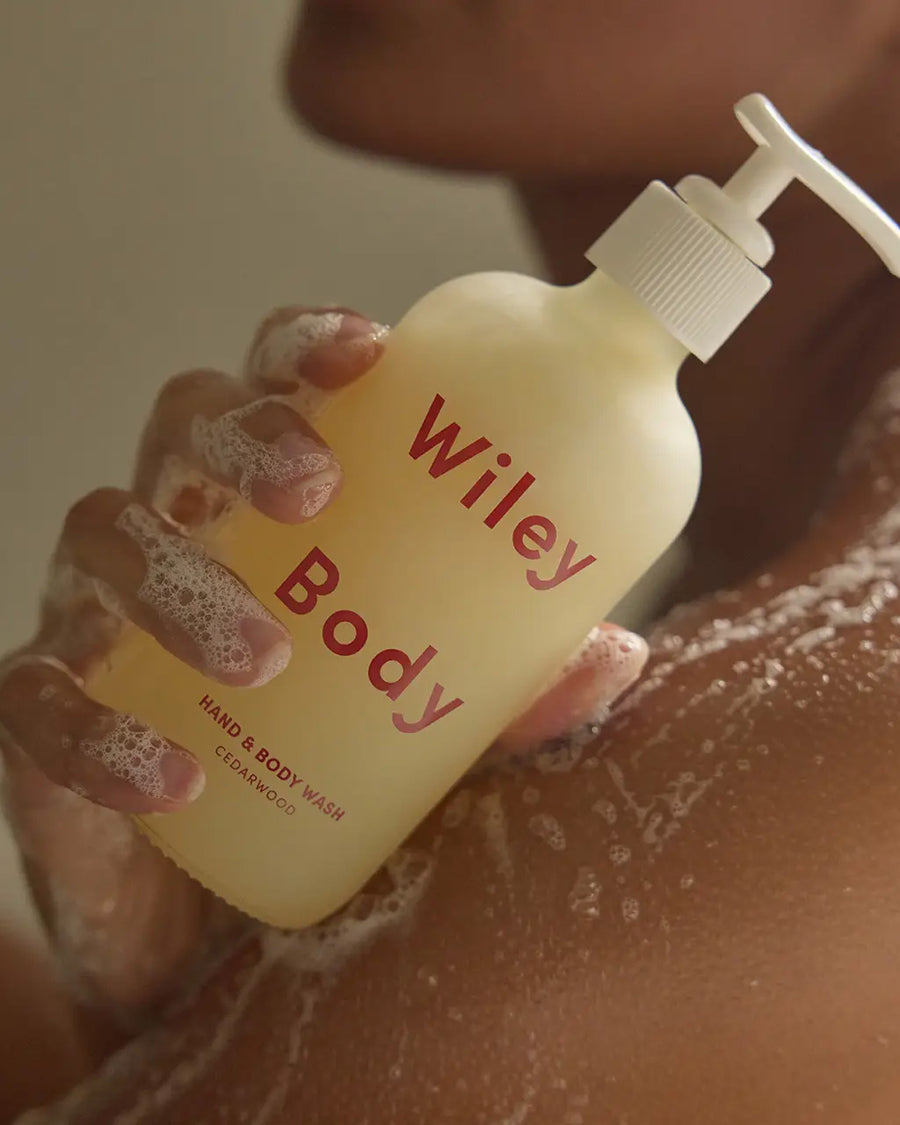 model holding cedarwood hand and body wash