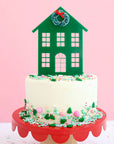 green house with wreath cake topper on a cake