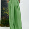 model wearing green wide leg trousers