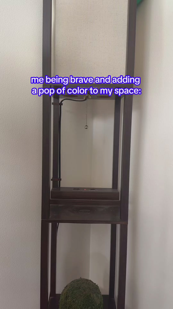 model putting white and blue oat milk vase on a table with the headline 'me being brave and adding a pop of color to my space.'