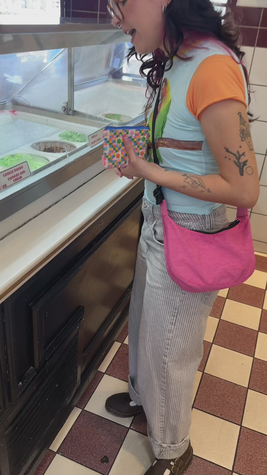 model using colorful star checker coin purse to buy ice cream