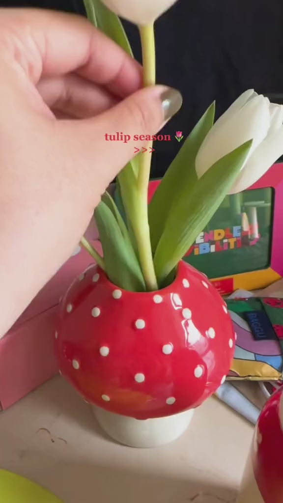 video of arranging white tulips in the mushroom vase