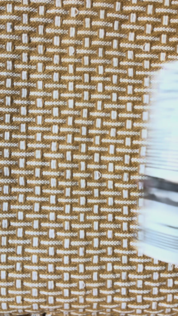 newspaper vase with yellow flowers inside