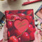 model putting photos into cherry photo album