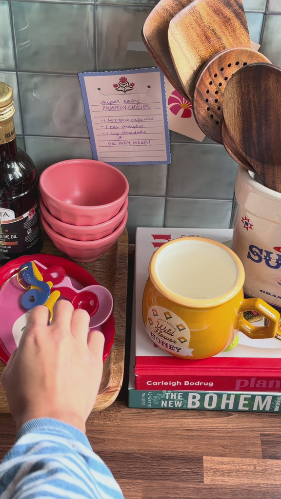 model showcasing colorful metal measuring spoons