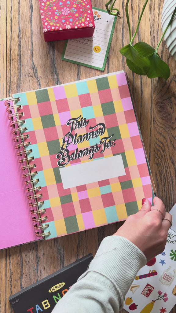 model flipping through 17-month planner
