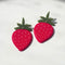 model showcasing strawberry shaped earrings