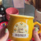 model showcasing yellow wild honey mug