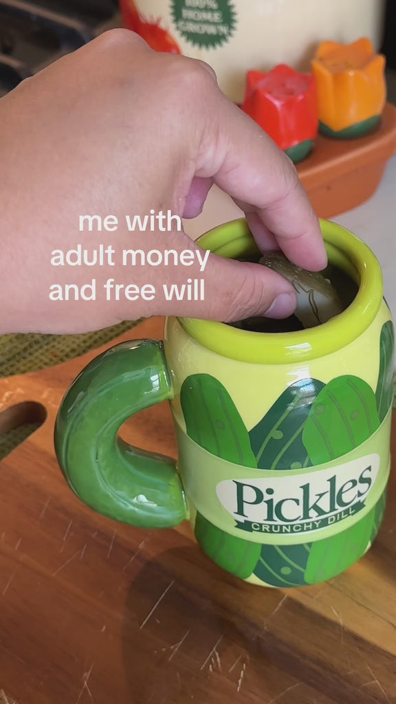model making pickles in a pickle jar mug with the caption 'me with adult money and free will'