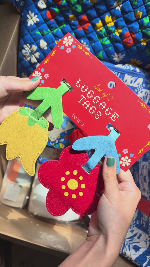model showcasing flower luggage tag set