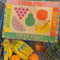 model grocery shopping with rattan market tote with colorful fruit tile accents