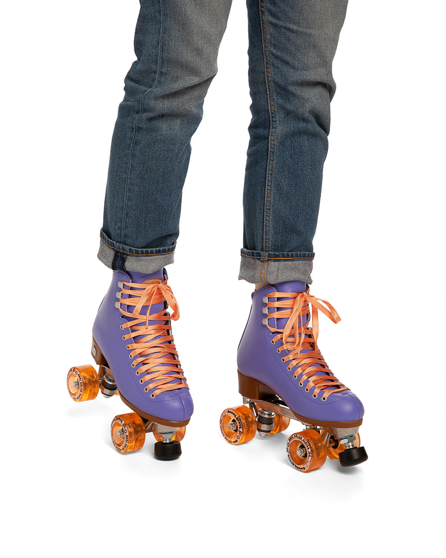 These periwinkle-colored roller-skates feature peach laces and sparkly peach wheels.
