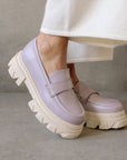 model wearing mauve platform loafers with white sole