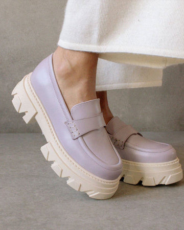 model wearing mauve platform loafers with white sole